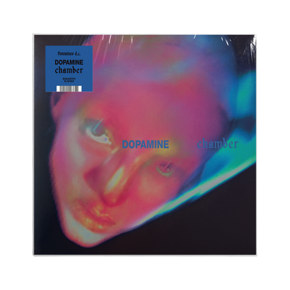 Vinyl record cover for 'Dopamine chamber', featuring a close-up portrait of a neon distorted face on a black background.
